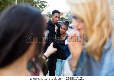 Racism - black couple being bullied, people pointing with finger on them