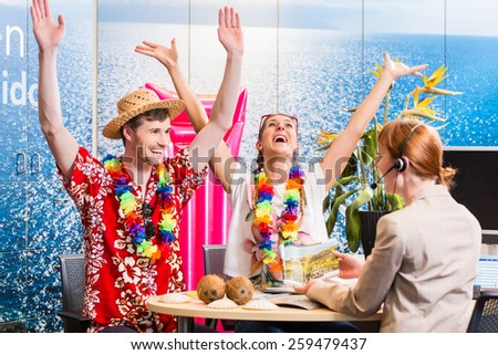 Man and woman booking vacation in travel agency cheering for a good deal