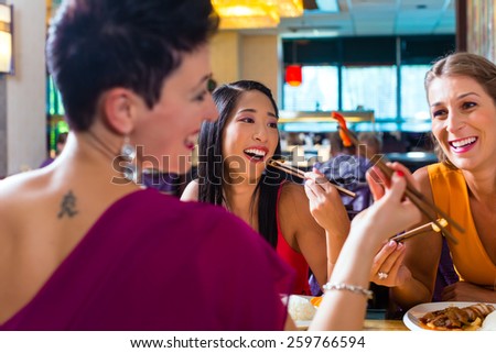 Young people eating in Asia restaurant