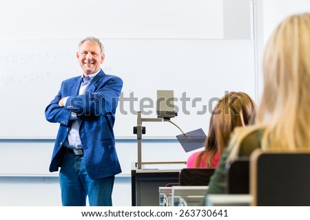 College professor giving lecture in college standing at desk