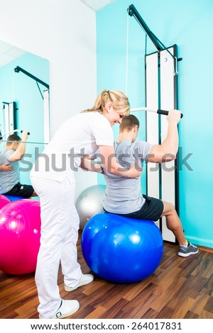 Patient at the physiotherapy doing physical exercises with therapist in sport rehabilitation