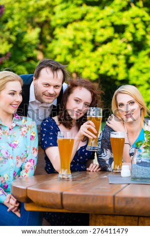 Friends sitting in beer garden restaurant