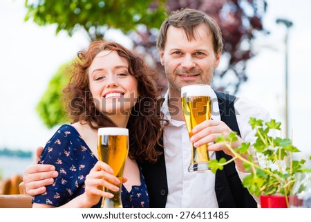 Man and woman drinking in beer garden pub
