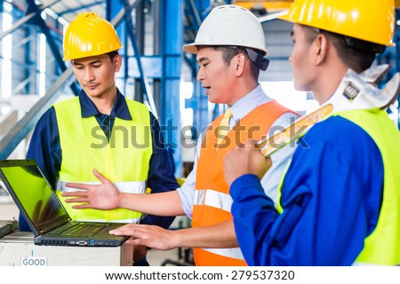 Team of workers and engineer  in Factory at production training with laptop