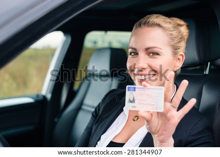 Woman showing her driving license out of car window