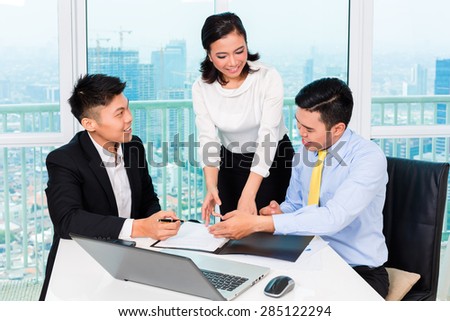 Asian banker counseling client finance investment in bank office