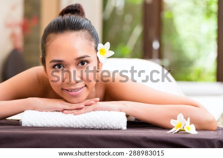 Indonesian Asian woman in wellness beauty day spa having aroma therapy massage with essential oil, looking relaxed