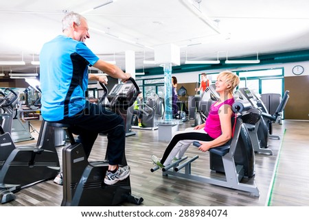 Senior man and woman in circle training doing sport exercising in gym
