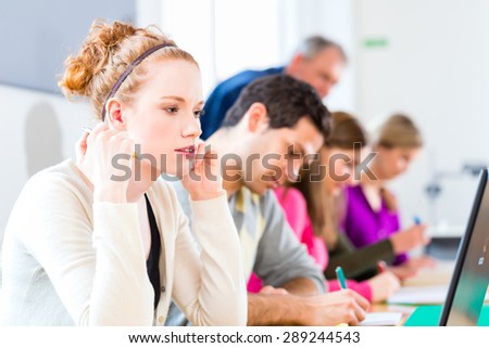 University college students having examination, the professor overseeing
