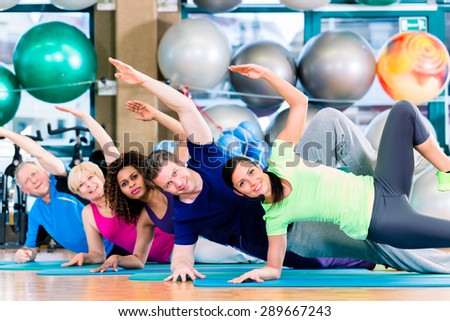 Gymnastic group in gym exercising and training, diversity people, old, young, black and white