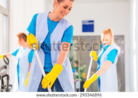 Commercial cleaning brigade working mopping the floor