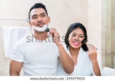 Asian morning couple, man and woman, in bathroom with makeup and shaver