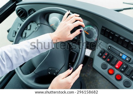 Bus driver in cockpit at the wheel driving