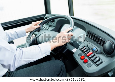 Bus driver in cockpit at the wheel driving