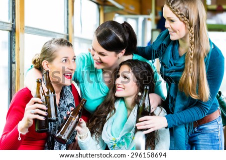Group of people in tram bar having beer party in public transport