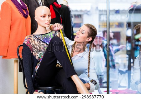 Window dresser or small business owner decorating shop display