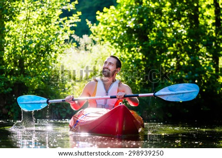 Man paddling with kayak on river for water sport