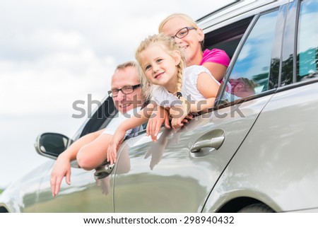 Family car - Father driving with daughters in auto