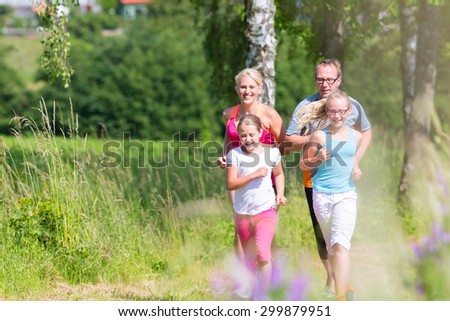 Family running for better fitness in summer through beautiful landscape