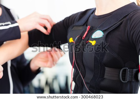 Female coach dress woman in ems electro muscular stimulation costume