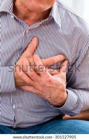 Old man holding breast because of heart infarction