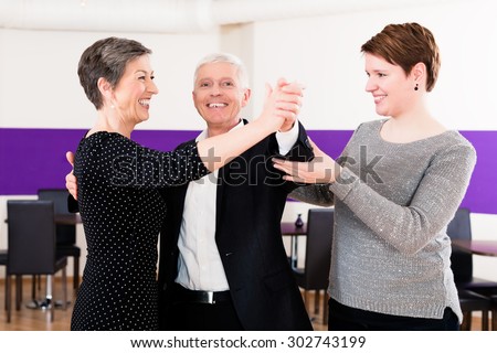 Dance instructor with senior couple of woman and man