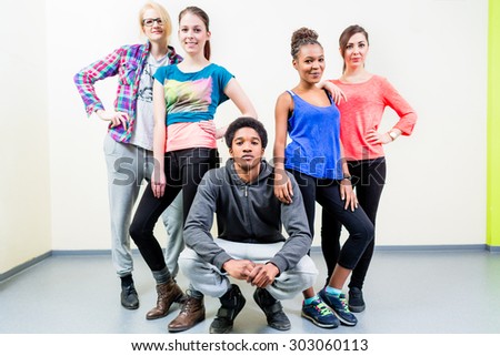 Young men and women in dance class posing