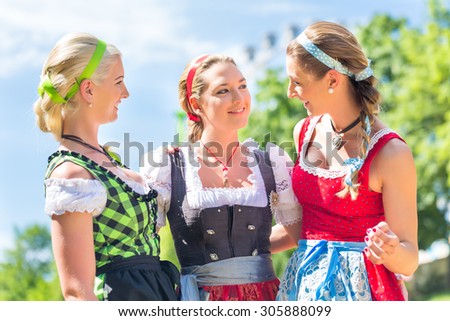 Women friends visiting Bavarian fair in national costume or Dirndl