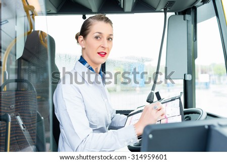 Female bus driver in drivers seat