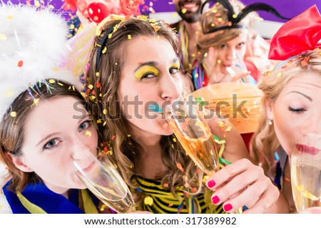 People on party drinking champagne and celebrating birthday or new years eve