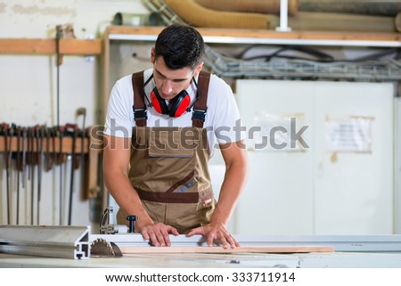 Carpenter or cabinet maker in his wood workshop