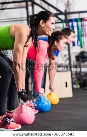 Functional fitness workout in sport gym with kettlebell