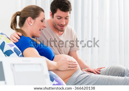 Pregnant woman in delivery room with her man