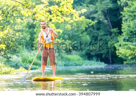 Man paddling on SUP in river