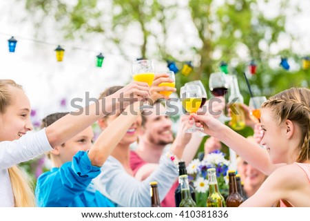 Friends and neighbors toasting on garden party