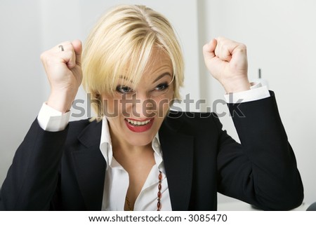 Business woman in a suit expressing joy or being successful