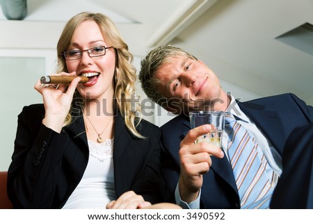 A mini after work party, smoking and drinking business couple (already rather drunk)