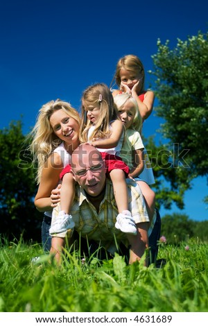 Wife and daughters horse riding daddy – all of them looking happy