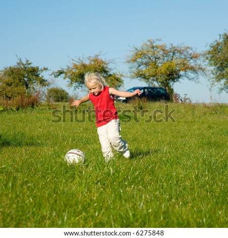 kicking soccer ball. girl kicking a soccer ball