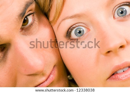 Couple with a rather strange look in their faces; her eyes wide open