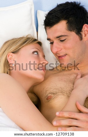 Young loving couple in bed in a sensual mood