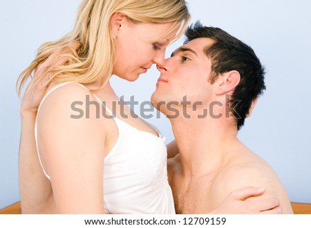 Young loving couple in a sensual mood, kissing and hugging each other