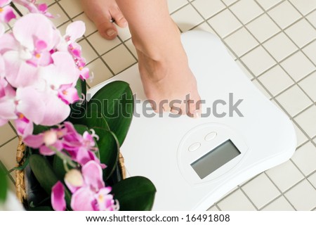 Woman (only feet to be seen) stepping on a scale in a spa setting