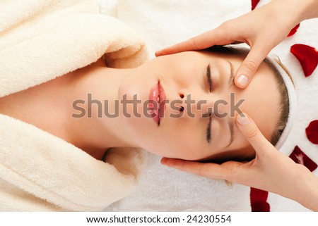 Beautiful woman enjoying a face massage competently carried out in a spa