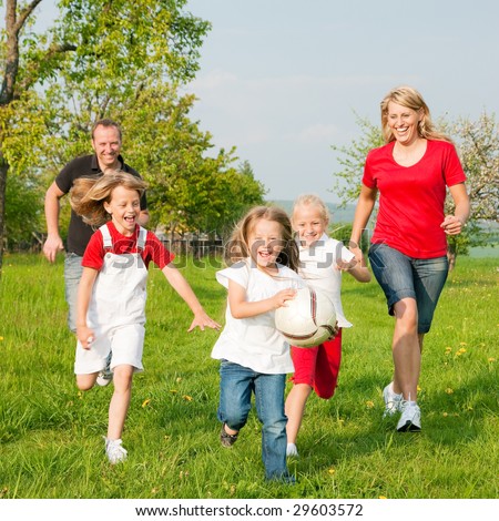 Игры для детей Stock-photo-happy-family-playing-football-one-child-has-grabbed-the-ball-and-is-being-chased-by-the-others-29603572