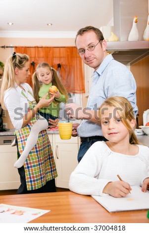 Everyday life of a family - kids doing their homework in the kitchen before going to school