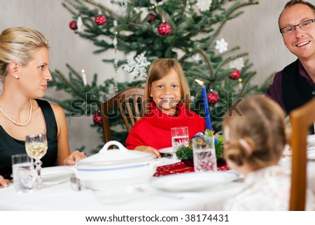 family around christmas tree clipart. stock photo : Family eating a