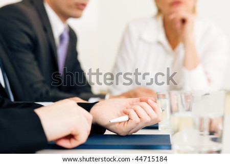 Small business team or working group having a brainstorm meeting in the office, very close-up shots on details, focus on hands in front