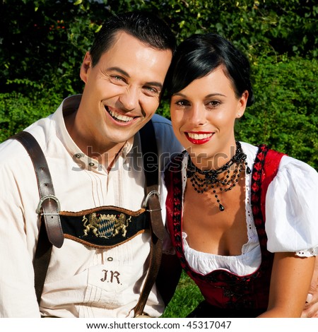 Couple Man And Woman In Traditional Bavarian Dress Lederhosen And Dirndl 