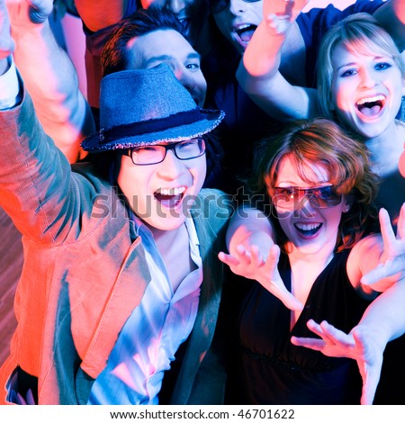 Crowd cheering - their rock idol or simply having fun in a club or disco party